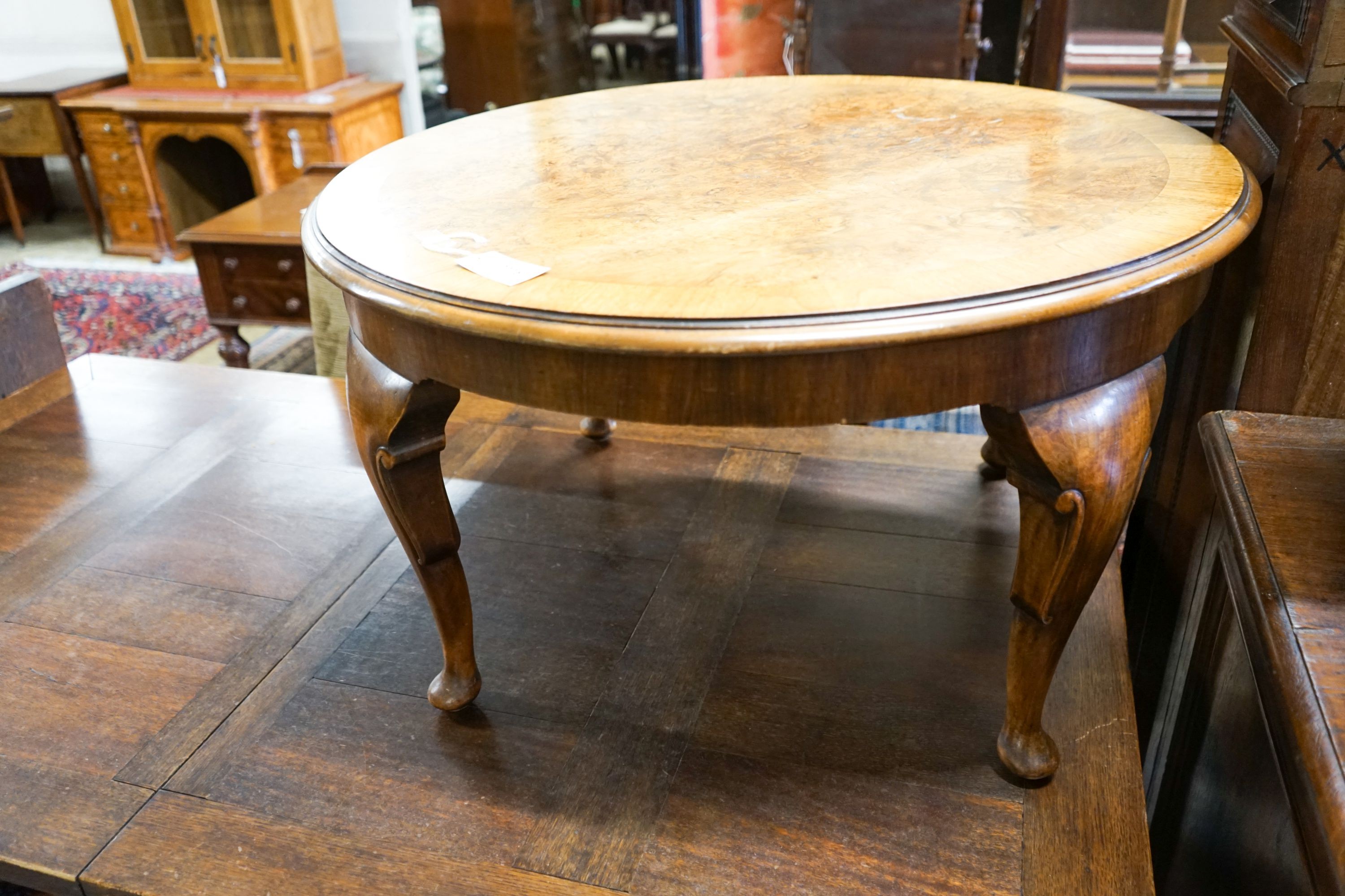 A circular burr walnut cabriole leg coffee table, diameter 84cm, height 47cm together with two Continental mahogany side tables with fretted brass galleries